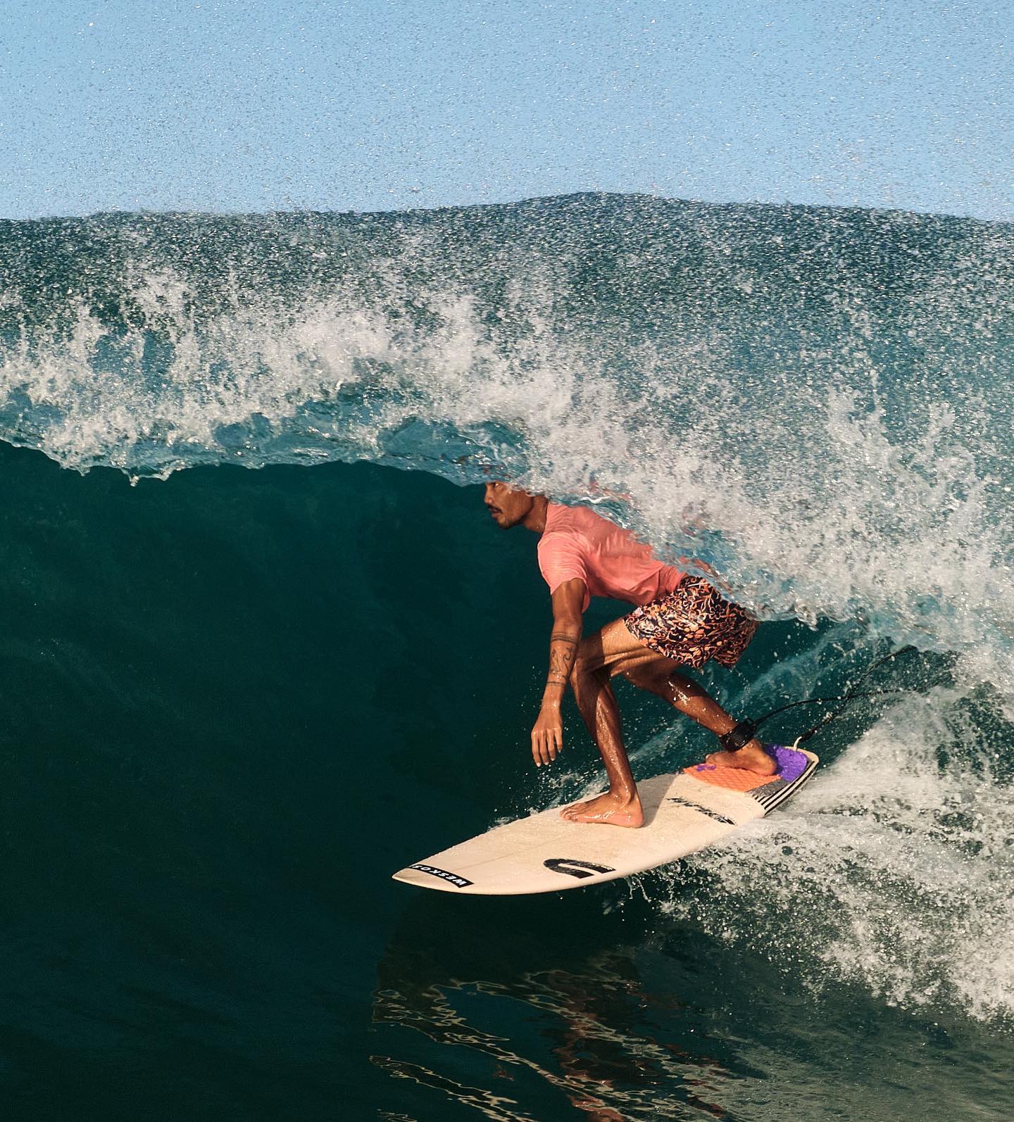 Surfer inside a curling barrel wave