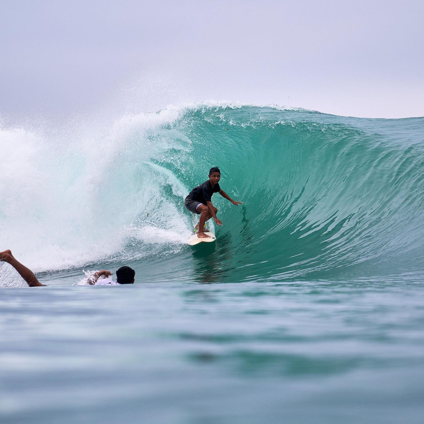 Surfer on a blue Krui wave