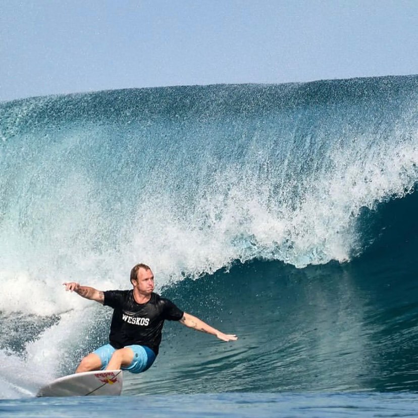 Wide view of a surfer riding a wave